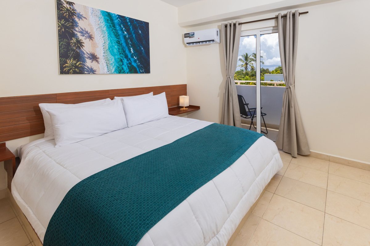 King room with private balcony and palm tree view